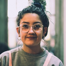 a photo of a brown female wearing glasses